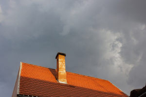 chimney high up on roof with cap