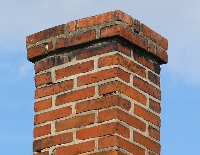 Dirty chimney crown with pieces of mortar falling out between the bricks that can cause leaks.