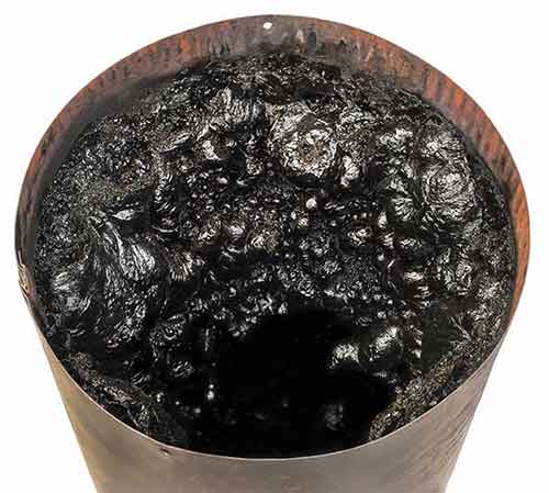 Creosote Removal An 8" pipe filled with creosote It has a 3" opening that is not covered with creosote.